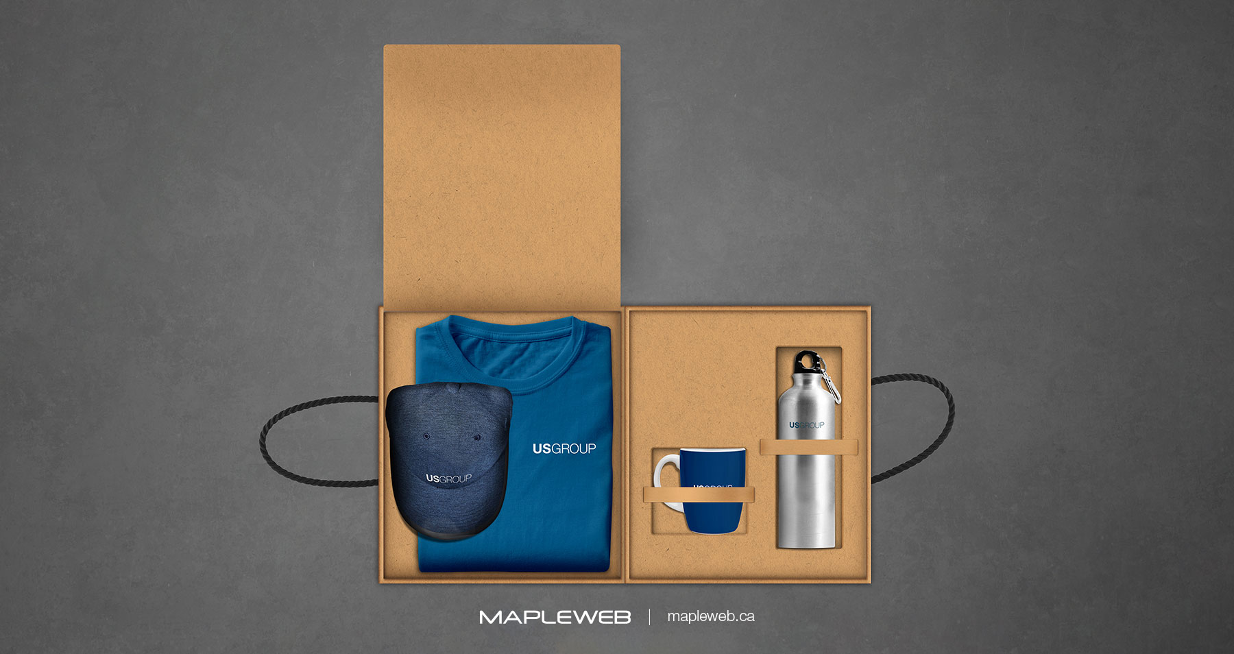 Us Group Open Wooden Box Having Blue Shirt Mug Bottle and Cap Brand design by Mapleweb